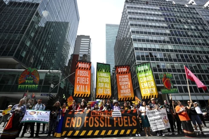 Tens of thousands march to kick off climate summit, demanding end to warming-causing fossil fuels