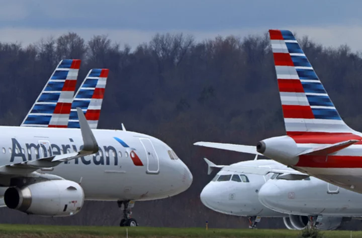 American Airlines raises its forecast of second-quarter profit, citing strong revenue, cheaper fuel